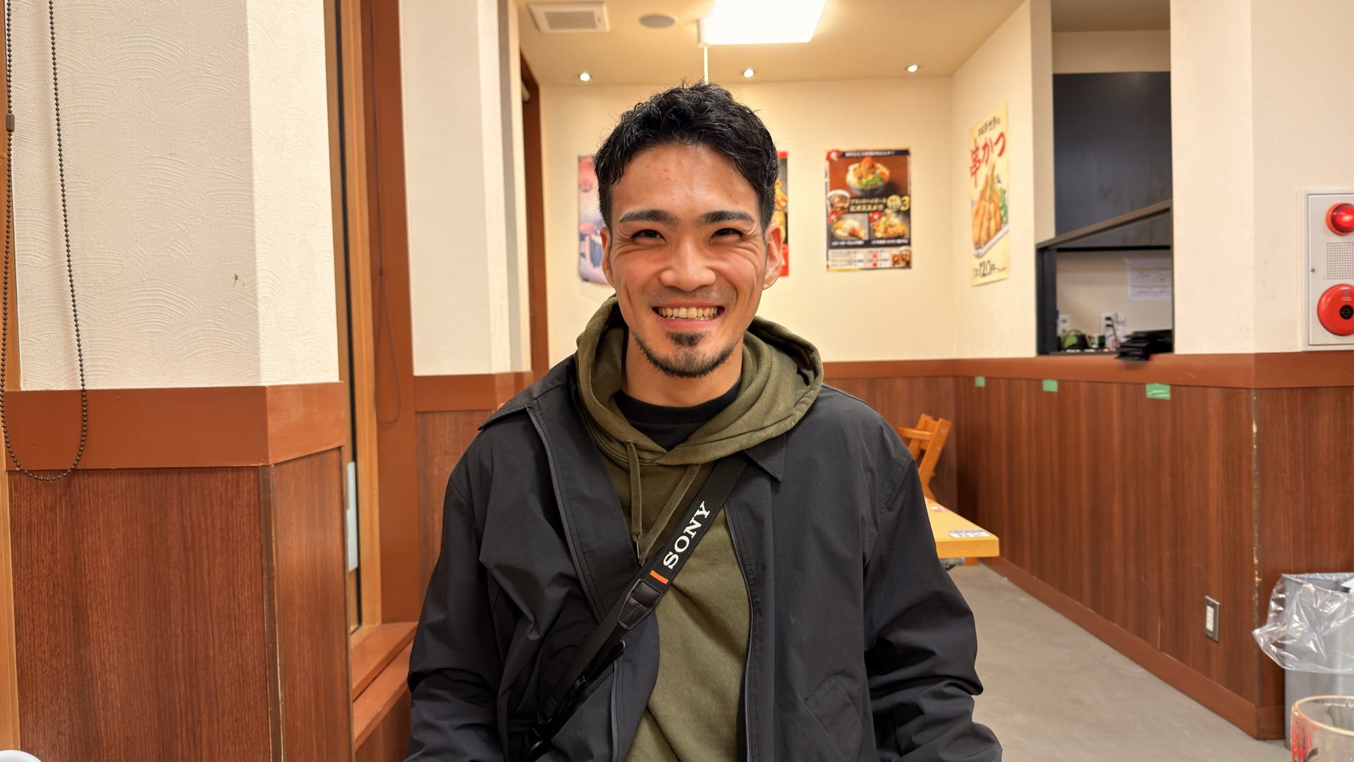 Ryusei, your Osaka guide, smiling at a local kushikatsu shop